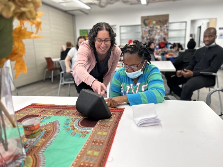 Susan in WAE Center helping people learn assistive tech as part of the JSDD: Life Home Tech program