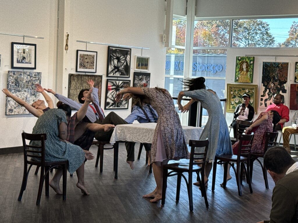 Group of people standing out of their chairs with their hands above their heads